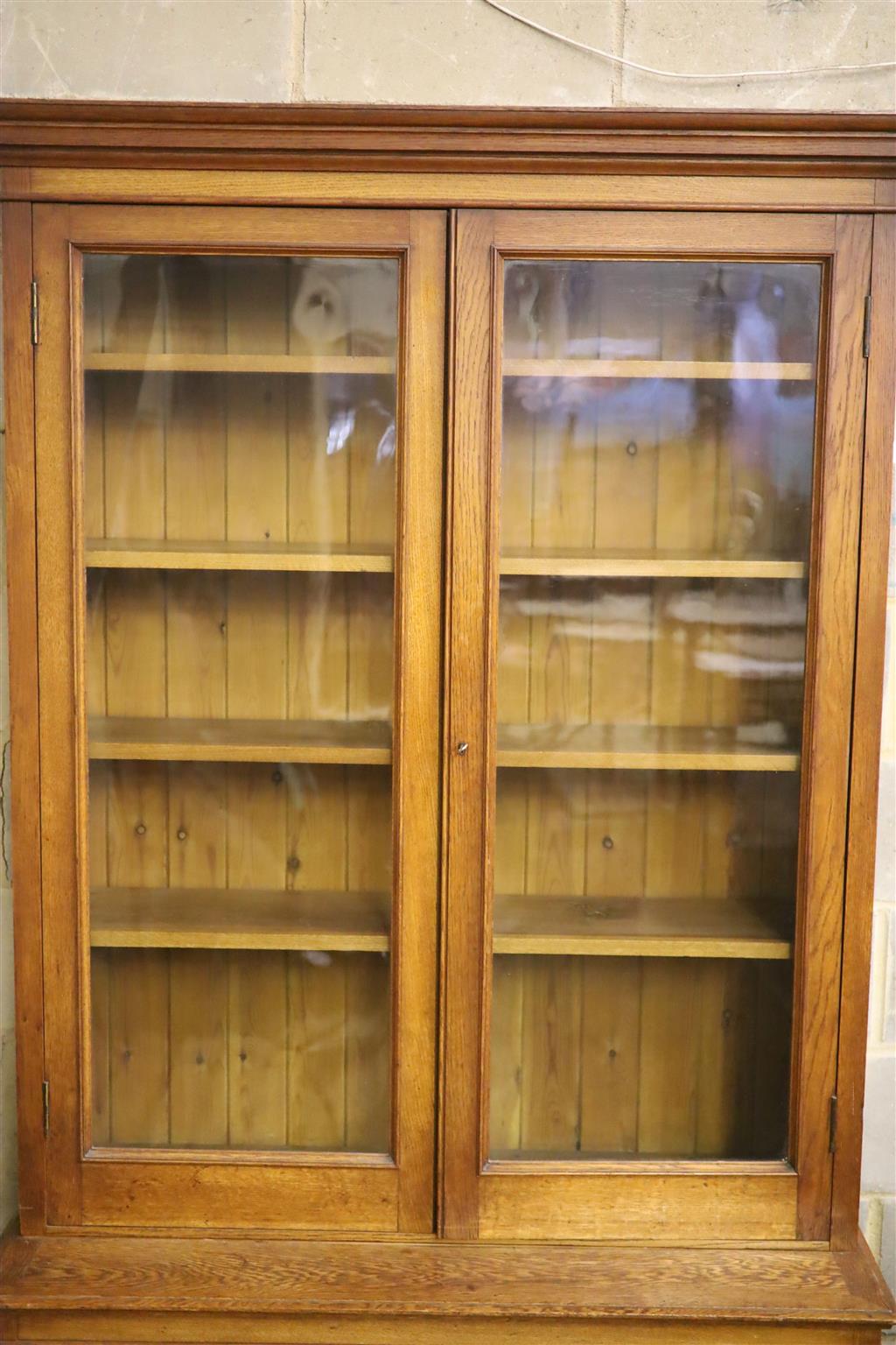 A late 19th century panelled oak library bookcase, length 118cm, depth 47cm, height 223cm